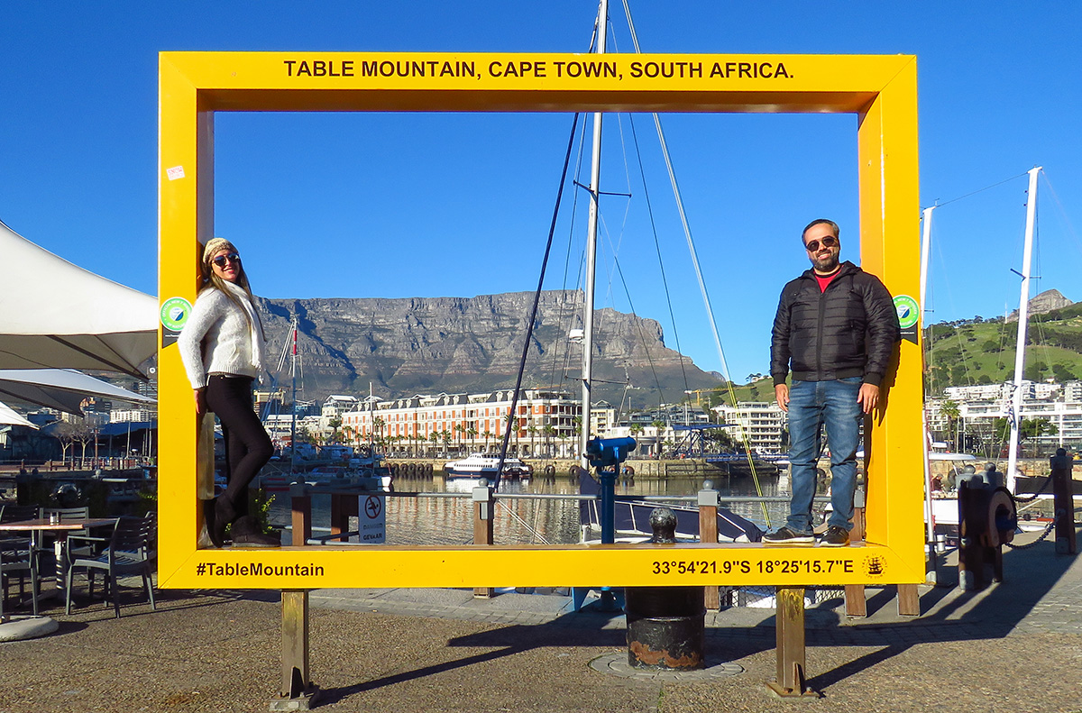 Casal na placa com a Table Mountain ao fundo